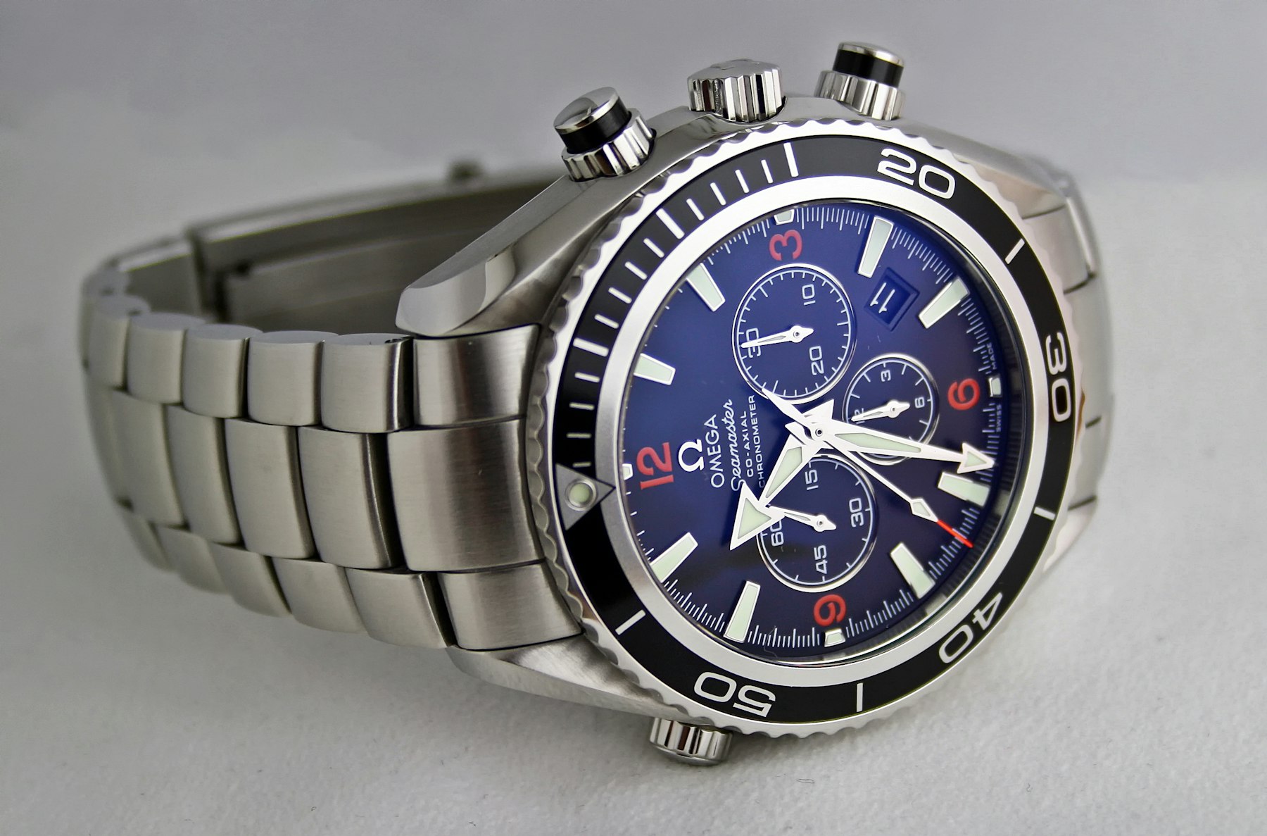 Steel Omega chronograph on a light surface